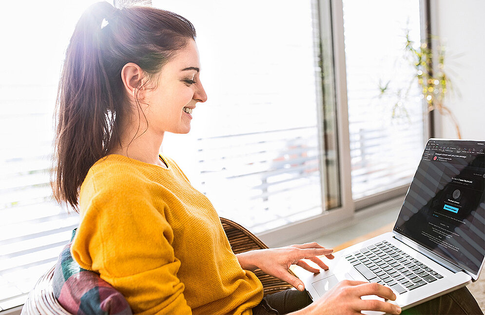 Phishing-simulatie versterkt veiligheidsbewustzijn Gelukkige vrouw met laptop op schoot